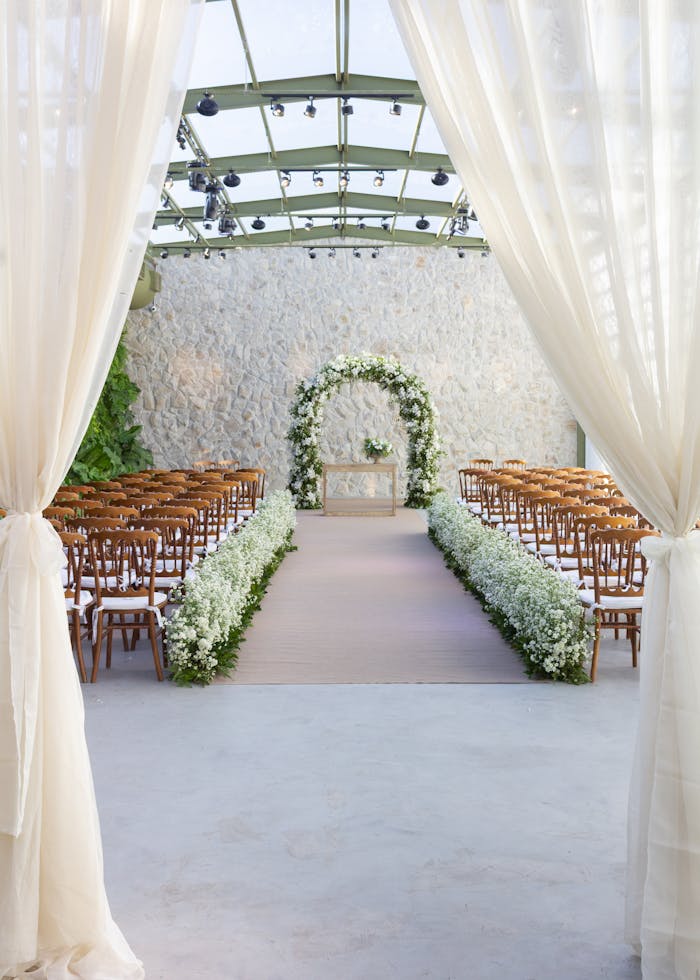 pexels photo 34808251 Beautifully arranged ceremony setup with floral arch in São Paulo, perfect for weddings.